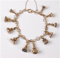 Lot 2206 - A 9ct charm bracelet set with eleven miniature...