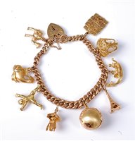 Lot 2186 - A 9ct gold charm bracelet, the curblink...