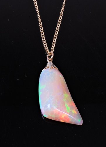 Lot 2283 - An opal pendant, the naturalistic opal pendant,...