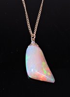 Lot 2283 - An opal pendant, the naturalistic opal pendant,...