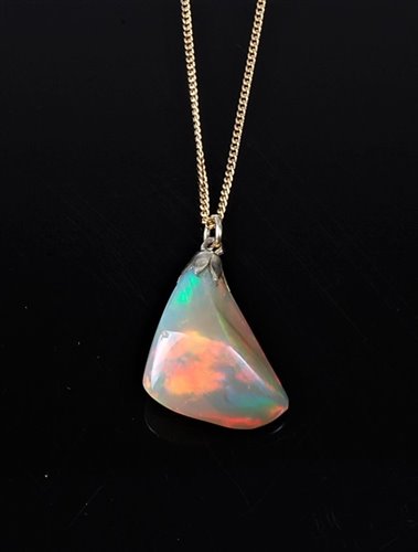 Lot 2220 - An opal pendant, the naturalistic opal pendant,...