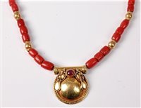 Lot 2281 - A coral and ruby necklace, the disc pendant,...