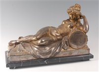 Lot 2409 - A large silvered bronze figure of a recumbent...