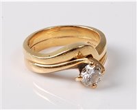 Lot 2190 - An '18k' gold diamond solitaire ring and...