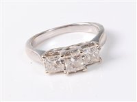Lot 2217 - A '14k' three stone diamond ring, the three...