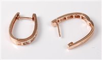 Lot 2196 - A pair of '14k' diamond earrings, the oval...