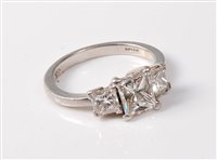 Lot 2317 - A platinum three stone diamond ring, the three...