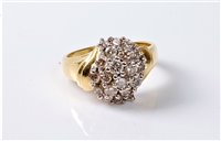 Lot 2307 - An 18ct diamond cluster ring, the curved...