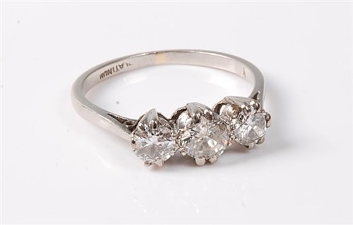 Lot 2257 - A platinum three stone diamond ring, the three...