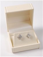 Lot 2305 - A pair of diamond cluster earrings, the...