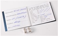 Lot 2301 - A pair of 18ct diamond earrings, the 5mm wide...