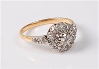 Lot 2319 - An 18ct diamond cluster ring, the central...