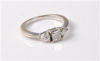 Lot 2259 - An 18ct three stone diamond ring, the central...