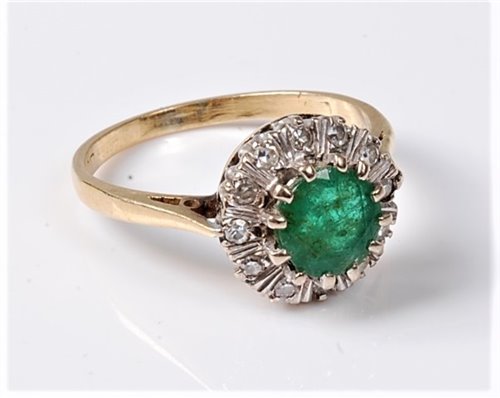 Lot 2214 - An 18ct emerald and diamond cluster ring, the...