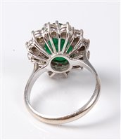 Lot 2231 - An emerald and diamond cluster ring, the oval...