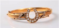 Lot 2324 - A diamond and pearl horseshoe bangle, the...