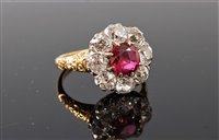 Lot 2265 - A ruby and diamond ring, the central round...