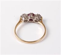 Lot 2284 - An 18ct three stone ruby and diamond ring, the...