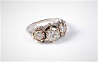 Lot 2228 - A three stone diamond cluster ring, the three...
