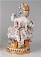 Lot 2097 - A Meissen porcelain figure of a seated girl in...