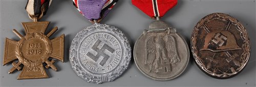 Lot 98 - A German Cross of Honour with swords, together...