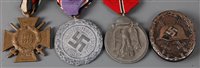 Lot 98 - A German Cross of Honour with swords, together...