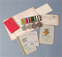Lot 380 - A group of four medals to include WW II...