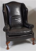 Lot 2689 - A Georgian style wingback open armchair,...