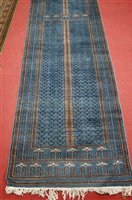 Lot 2634 - A Persian woollen blue ground hall runner, the...