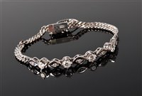 Lot 2179 - A 14ct diamond bracelet, comprised of four...