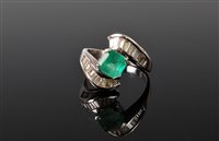 Lot 1213 - An 18ct emerald and diamond crossover ring,...