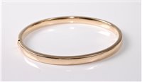 Lot 324 - A 5mm wide hinged bangle with concealed clasp...