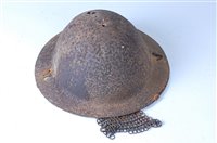 Lot 653 - A British Brodie pattern tin helmet with...