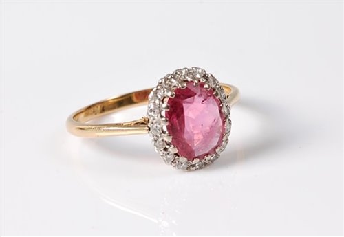 Lot 1188 - An 18ct pink sapphire and diamond ring, the...