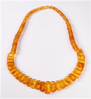 Lot 301 - An amber necklace, the half set graduated...