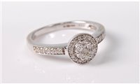 Lot 358 - An 18ct white gold diamond ring, the central...