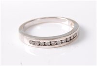 Lot 371 - A 9ct white gold half hoop diamond ring, total...