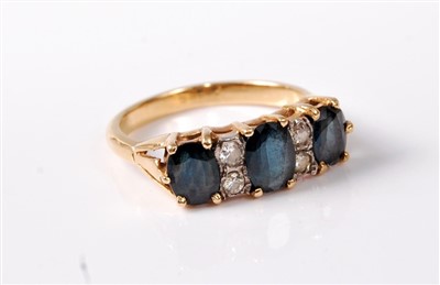 Lot 373 - An 18ct sapphire and diamond ring, the deep...