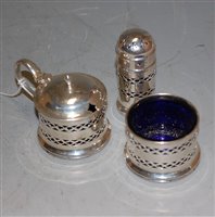 Lot 282 - A silver three piece cruet set with blue glass...