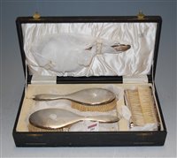 Lot 284 - An Art Deco cased silver backed five piece...