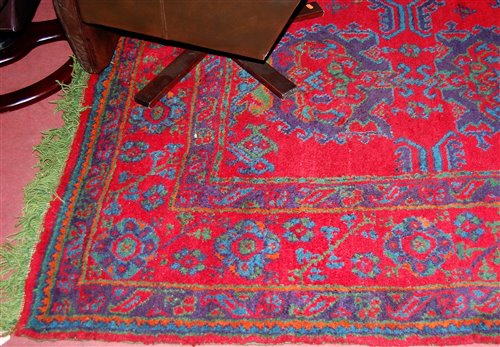 Lot 1146 - A Persian style red ground woollen rug by...