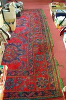Lot 1146 - A Persian style red ground woollen rug by...