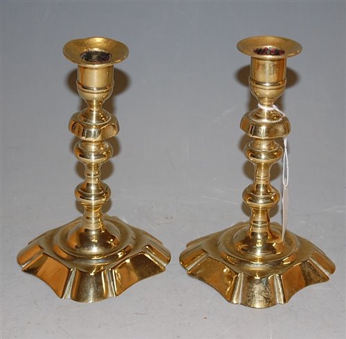 Lot 33 - A pair of 18th century brass candlesticks with...