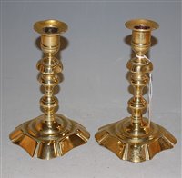 Lot 33 - A pair of 18th century brass candlesticks with...