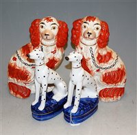 Lot 51 - A pair of Staffordshire seated spaniels, each...