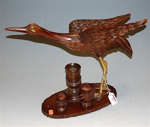 Lot 53 - A carved softwood model of a crane on stand