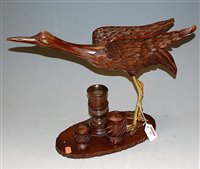 Lot 53 - A carved softwood model of a crane on stand