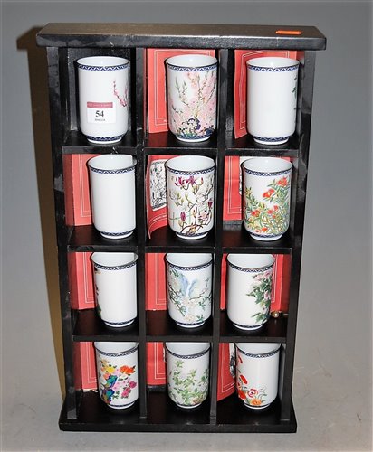 Lot 54 - A set of twelve Japanese porcelain beakers,...