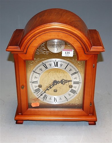 Lot 125 - A reproduction yew wood cased domed top mantel...