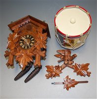 Lot 157 - A contemporary stained wood cuckoo clock; and...